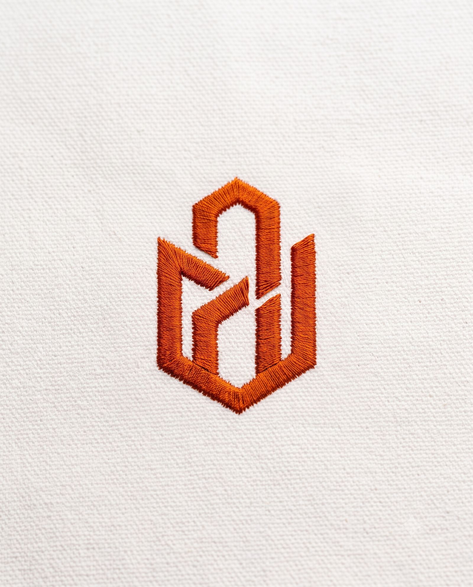 VSR7817 Embroidered Orange Logo on White Fabric Macro Detail